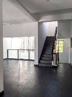 The stair at the first floor level from where it leads to the terrace above.

On the left is the family space which looks down into the small courtyard on its south side and into the entrance foyer on the north side.